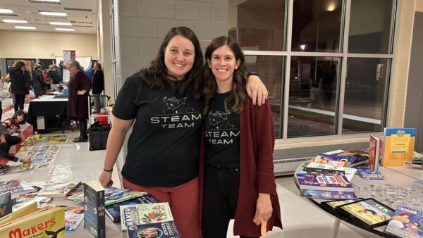 Two volunteers at STEAM night pose for a picture